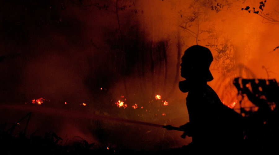 Firefighters fight the fire at night. Outside Palangka Raya, Central Kalimantan.